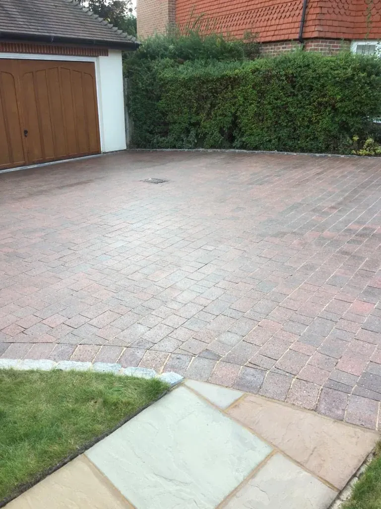 Buff tumbled block paving driveway laid in a random pattern