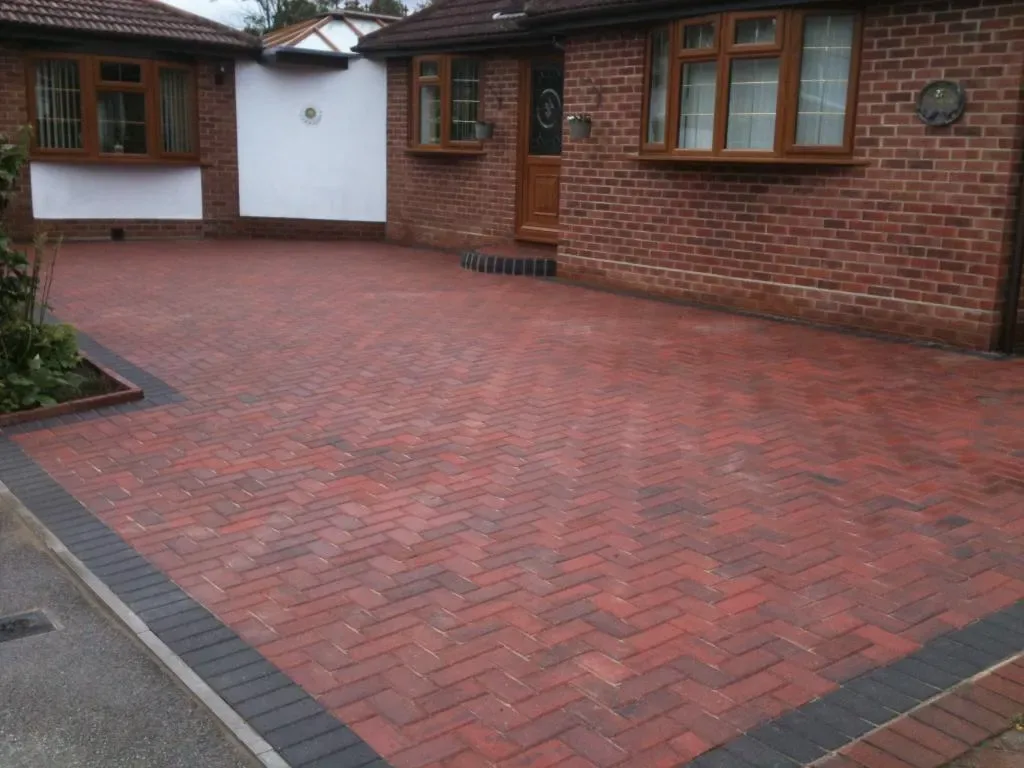 Grey block paving driveway with a clean charcoal perimeter course