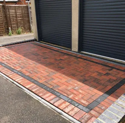 Close view of block paving joints and cut detail around a manhole