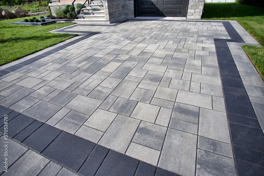 Block paved frontage with planted borders either side
