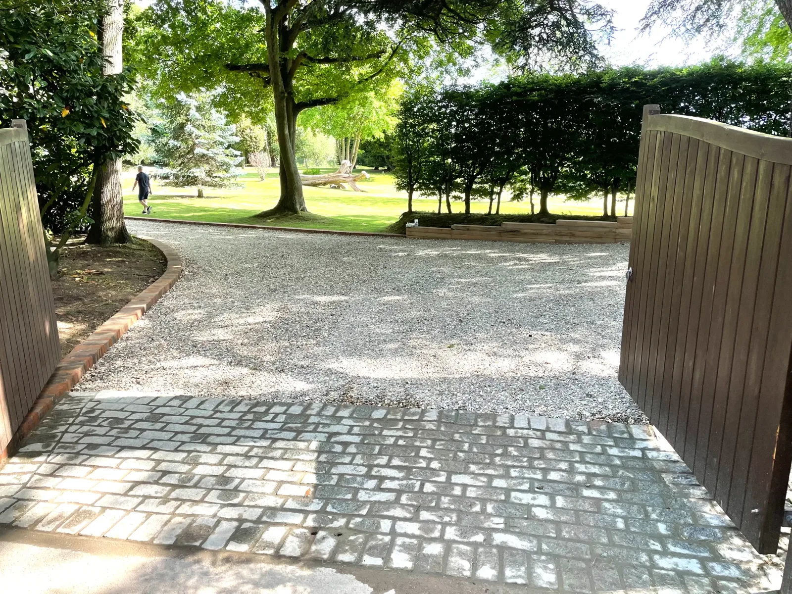 Gravel driveway with a stabilising grid beneath the top layer of stone