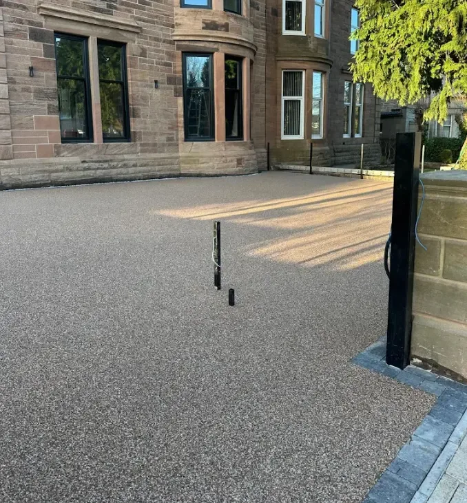 Resin bound driveway trowel finished up to the garage threshold