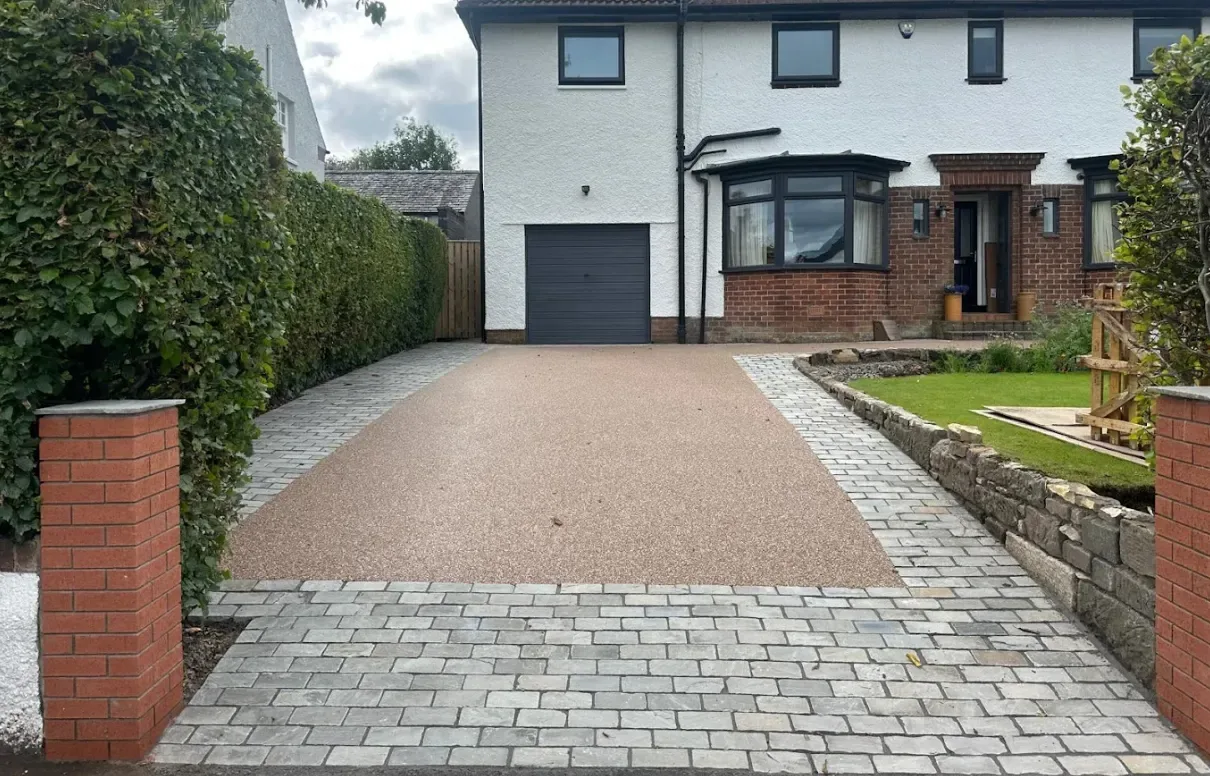 Resin bound driveway with a low retaining wall alongside