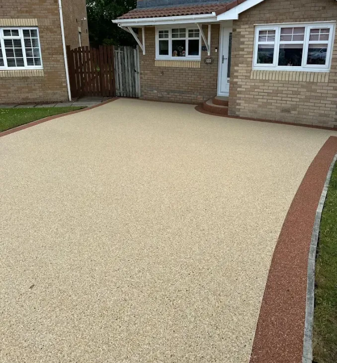 Resin bound driveway cut neatly around a drainage channel