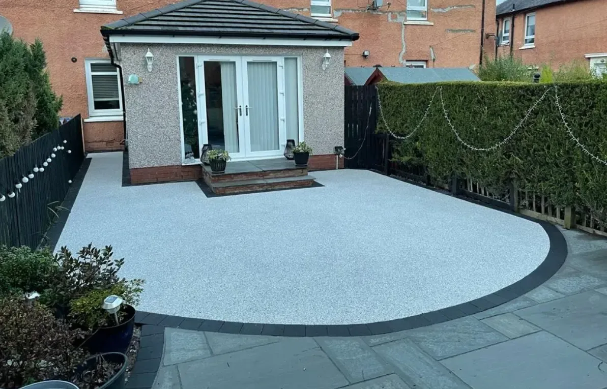 Permeable resin bound patio finished against a low garden wall