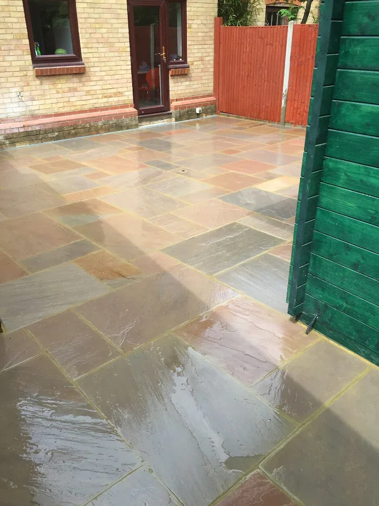 Sandstone paving laid in a mixed size random pattern