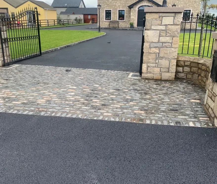 Machine-laid tarmac driveway rolled to a smooth black finish