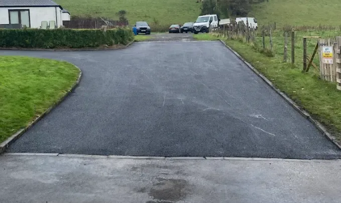Tarmac surface finished flush against a drainage channel